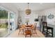 Bright dining area with a modern light fixture and sliding glass doors to the backyard at 123 Lyra Ln, Summerville, SC 29486