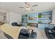 Bright living room with custom blue built-ins, display shelving, and a ceiling fan at 123 Lyra Ln, Summerville, SC 29486