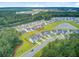This aerial view captures a community with a pond, green spaces, and well-maintained homes, promoting a suburban lifestyle at 135 Cypress Preserve Blvd, Moncks Corner, SC 29461