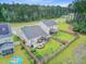 Aerial view of a backyard featuring a garden, patio, and fenced-in yard with trees, creating a tranquil outdoor space at 135 Cypress Preserve Blvd, Moncks Corner, SC 29461