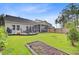 A backyard with a patio area, screened in porch, and garden, perfect for outdoor enjoyment at 135 Cypress Preserve Blvd, Moncks Corner, SC 29461