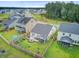 Aerial view of a fenced backyard featuring a garden, screened patio, outdoor furniture and play area at 135 Cypress Preserve Blvd, Moncks Corner, SC 29461