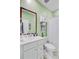 Fresh green bathroom featuring white vanity, modern sink fixture, large mirror and toilet with rack at 135 Cypress Preserve Blvd, Moncks Corner, SC 29461