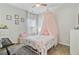 Girly bedroom with large canopy bed and piano on a grey rug, great natural light at 135 Cypress Preserve Blvd, Moncks Corner, SC 29461