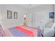 Comfortable bedroom features a chair, colorful bedspread, and closet door access at 135 Cypress Preserve Blvd, Moncks Corner, SC 29461