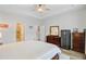 Bright bedroom featuring tray ceilings, a wooden dresser, and a large, secure gun safe for peace of mind at 135 Cypress Preserve Blvd, Moncks Corner, SC 29461