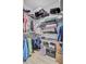 Walk-in closet with metal shelving holding shoes, totes, suitcases, and hanging clothes at 135 Cypress Preserve Blvd, Moncks Corner, SC 29461