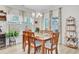 Charming dining room with wood table, bright windows, modern light fixtures, and beverage cooler at 135 Cypress Preserve Blvd, Moncks Corner, SC 29461