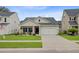 Inviting single-story home with a tidy lawn, two-car garage, and a welcoming front porch at 135 Cypress Preserve Blvd, Moncks Corner, SC 29461
