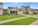 Attractive single-story home featuring a well-kept lawn, an attached garage, and a charming front porch at 135 Cypress Preserve Blvd, Moncks Corner, SC 29461