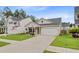 Pleasant single-story home with a tidy lawn, attached two-car garage, and cozy front porch at 135 Cypress Preserve Blvd, Moncks Corner, SC 29461