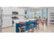 Spacious kitchen with white cabinets, a blue island and a dining area with natural lighting at 135 Cypress Preserve Blvd, Moncks Corner, SC 29461