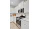 Clean kitchen with white cabinets, stainless steel range and microwave, and white subway tile backsplash at 135 Cypress Preserve Blvd, Moncks Corner, SC 29461