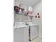 Well-organized laundry room with washer, dryer, and shelving for storage, making laundry a breeze at 135 Cypress Preserve Blvd, Moncks Corner, SC 29461