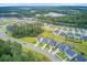 Wide aerial shot showcases a vibrant community with mature trees and green spaces near suburban homes at 135 Cypress Preserve Blvd, Moncks Corner, SC 29461
