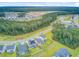 Overhead view of a suburban community featuring modern homes, community amenities, and lush landscaping at 135 Cypress Preserve Blvd, Moncks Corner, SC 29461
