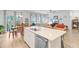 Open floorplan with kitchen island, a dining area, and a living room with fireplace feature at 135 Cypress Preserve Blvd, Moncks Corner, SC 29461