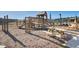Community playground featuring a wooden playset, swings, picnic table, and seating, with a pool and homes in the background at 135 Cypress Preserve Blvd, Moncks Corner, SC 29461