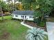 Charming home with well-manicured lawn, mature trees, and inviting curb appeal at 1351 Winifred St, Mount Pleasant, SC 29464