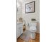 Charming bathroom with white vanity, hardwood floors, toilet, and tasteful decor at 1351 Winifred St, Mount Pleasant, SC 29464