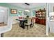 A dining room with a dark wood table and chairs beneath a decorative chandelier at 1351 Winifred St, Mount Pleasant, SC 29464