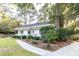 Charming single-story home featuring a inviting front porch, mature landscaping, and a well-maintained yard at 1351 Winifred St, Mount Pleasant, SC 29464