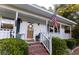Inviting front porch with brick steps, white railings, and cozy seating area at 1351 Winifred St, Mount Pleasant, SC 29464