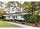 Charming single-story home with a well-manicured lawn, inviting walkway, and an American flag at 1351 Winifred St, Mount Pleasant, SC 29464
