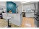 Modern kitchen bar area with stool seating and stylish blue accent wall at 1351 Winifred St, Mount Pleasant, SC 29464