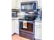 Close-up of the kitchen range with a stylish towel and stainless steel microwave oven at 1351 Winifred St, Mount Pleasant, SC 29464