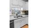 Stylish kitchen sink with decorative tile backsplash and grey countertops at 1351 Winifred St, Mount Pleasant, SC 29464