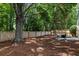 Fenced backyard with mature trees and seating area at 1420 Wellesley Cir, Mount Pleasant, SC 29466