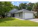 Charming single-story home with a well-manicured lawn, gray siding, and an attached two-car garage at 1420 Wellesley Cir, Mount Pleasant, SC 29466