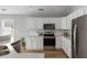 Beautiful kitchen featuring white cabinetry, stainless steel appliances, subway tile backsplash, and wood flooring at 1420 Wellesley Cir, Mount Pleasant, SC 29466