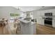 Modern kitchen with white cabinets, stainless steel appliances, quartz countertops, and barstool seating at 1420 Wellesley Cir, Mount Pleasant, SC 29466