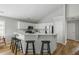 Bright kitchen features white cabinets, stainless steel appliances, breakfast bar, and stylish bar stools at 1420 Wellesley Cir, Mount Pleasant, SC 29466