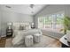 Bright bedroom with a large window, neutral decor, and cozy modern furnishings at 1420 Wellesley Cir, Mount Pleasant, SC 29466