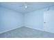 This bedroom offers neutral carpet, a ceiling fan, and pale blue paint at 1423 Ashley River Rd # 3A, Charleston, SC 29407