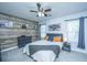 Bedroom featuring wood-look accent wall, soft carpet, neutral tones, and natural light at 1423 Ashley River Rd # 3A, Charleston, SC 29407
