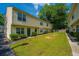 Townhome building featuring well-manicured lawn and green front doors at 1423 Ashley River Rd # 3A, Charleston, SC 29407