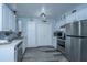 Updated kitchen with stainless steel appliances, white cabinets, and wood-look flooring at 1423 Ashley River Rd # 3A, Charleston, SC 29407