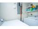 Bright laundry room with washer, dryer, storage shelf, and Dyson vacuum at 1423 Ashley River Rd # 3A, Charleston, SC 29407