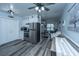 Open concept kitchen flows to living room with wood-look floors and stainless steel appliances at 1423 Ashley River Rd # 3A, Charleston, SC 29407
