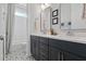 Bathroom featuring double vanities with a subway tile shower and patterned floors at 1535 Low Pk St, Mount Pleasant, SC 29464
