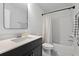 Cozy bathroom features a black vanity, white subway tiles and shower-tub combo at 1535 Low Pk St, Mount Pleasant, SC 29464