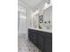 Bathroom with double vanity and patterned floors leading to shower-tub combo behind a sheer curtain at 1535 Low Pk St, Mount Pleasant, SC 29464