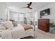 Bedroom with large window, ceiling fan and wooden dresser at 1535 Low Pk St, Mount Pleasant, SC 29464