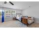 A charming bedroom with a metal bed frame, vintage chair and large windows at 1535 Low Pk St, Mount Pleasant, SC 29464