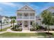 Charming two-story home featuring a double porch, lush landscaping, and an American flag at 1535 Low Pk St, Mount Pleasant, SC 29464