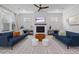 Bright living room with a fireplace, ceiling fan and two blue couches at 1535 Low Pk St, Mount Pleasant, SC 29464